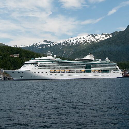 Cruise ship sailing past mountains on a long voyage