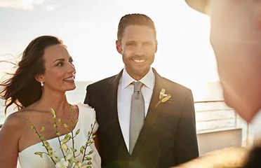 Bride and groom smiling on a cruise ship deck